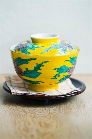 Ceramic rice bowl with lid on saucer Stock Photo - Premium Royalty-Free, Code: 633-02417847