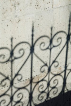 Shadow of ornate fence on wall Stock Photo - Premium Royalty-Free, Code: 633-02691270