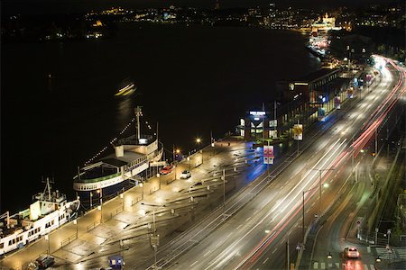 simsearch:633-02691316,k - Sweden, Stockholm, streets and dock illuminated at night Fotografie stock - Premium Royalty-Free, Codice: 633-02691306