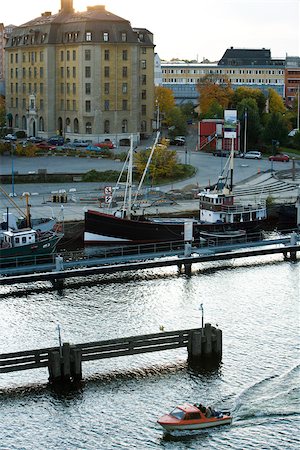 simsearch:633-02691316,k - Sweden, Stockholm, small motorboat touring along waterfront Fotografie stock - Premium Royalty-Free, Codice: 633-02691322