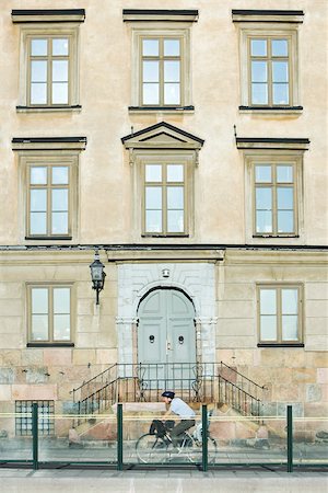 simsearch:633-03444681,k - Sweden, Stockholm, bicyclist riding in front of apartment building Stock Photo - Premium Royalty-Free, Code: 633-02691334