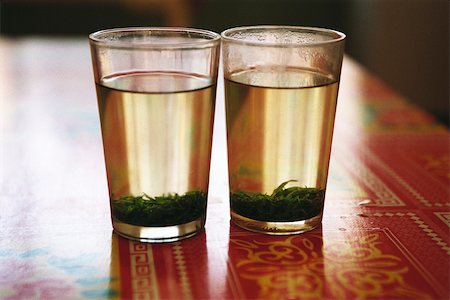 Two glasses of tea with tea leaves steeping Stock Photo - Premium Royalty-Free, Code: 633-02885718