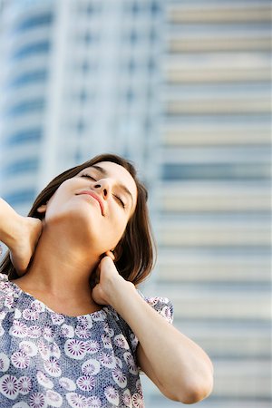 Woman massaging her neck, eyes closed Stock Photo - Premium Royalty-Free, Code: 633-03194589