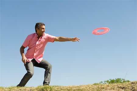 person throwing silhouette - Man throwing flying disc Stock Photo - Premium Royalty-Free, Code: 633-03194705