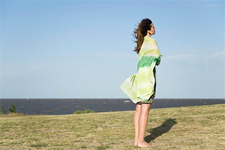 Woman standing outdoors barefoot, wrapped in shawl Stock Photo - Premium Royalty-Free, Code: 633-03194717