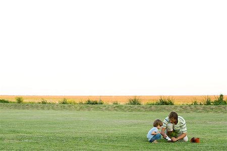 family yard work - Father and son planting seedling in field Stock Photo - Premium Royalty-Free, Code: 633-03194750