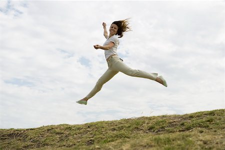 Woman jumping, midair Stock Photo - Premium Royalty-Free, Code: 633-03194805