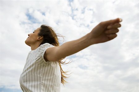 recharging - Woman with arms outstretched, head back, enjoying fresh air Stock Photo - Premium Royalty-Free, Code: 633-03194807