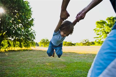 family playing in the grass - Parent spinning little boy in park Stock Photo - Premium Royalty-Free, Code: 633-03444463