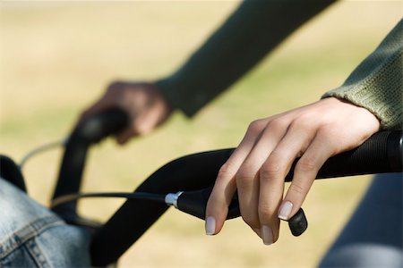 simsearch:633-03444681,k - Woman riding bicycle, cropped view Stock Photo - Premium Royalty-Free, Code: 633-03444679