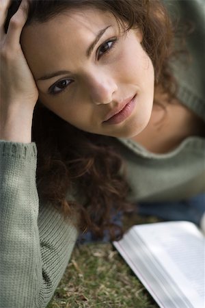 Young woman lying on ground with book, portrait Stock Photo - Premium Royalty-Free, Code: 633-03444690