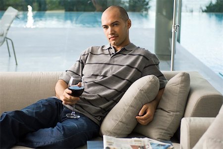 simsearch:640-01358445,k - Man relaxing on sofa with glass of wine Stock Photo - Premium Royalty-Free, Code: 633-03444966