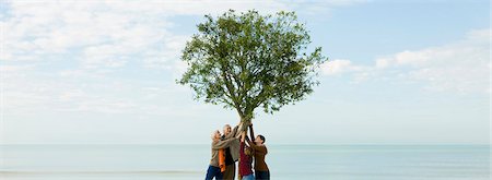 simsearch:633-03445015,k - Ecology conceZS, group of people supporting tree together Foto de stock - Sin royalties Premium, Código: 633-03444973