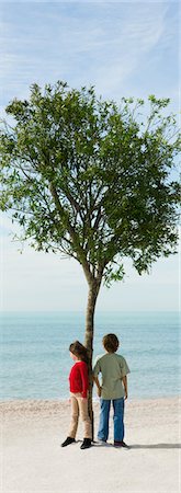 environmental issues for kids - Children standing by tree on beach looking at view Stock Photo - Premium Royalty-Free, Code: 633-03444987
