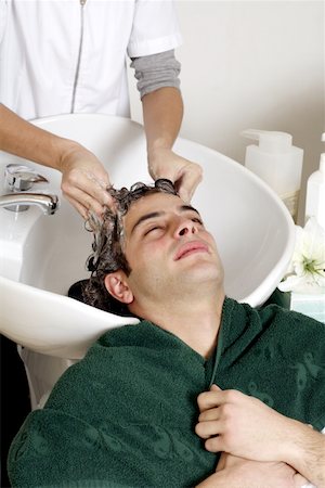 Young man having his hair  washed at a salon Stock Photo - Premium Royalty-Free, Code: 644-01435807