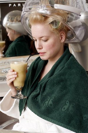 Young woman sitting under hairdryer Stock Photo - Premium Royalty-Free, Code: 644-01435838