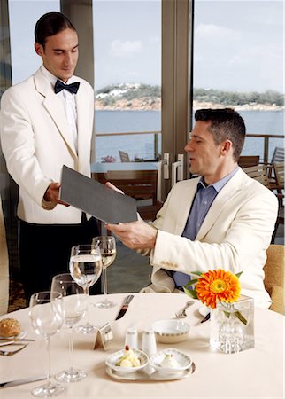 Waiter giving menu to customer in restaurant Stock Photo - Premium Royalty-Free, Code: 644-01435877
