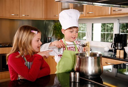 Children cooking spaghetti Stock Photo - Premium Royalty-Free, Code: 644-01436274