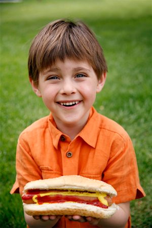 family cooking barbecues - Little boy holding a hot dog Stock Photo - Premium Royalty-Free, Code: 644-01436429