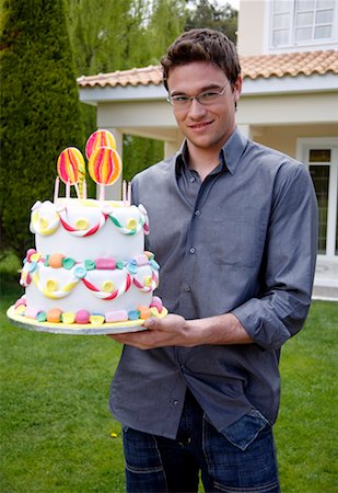 Man holding party cake Stock Photo - Premium Royalty-Free, Code: 644-01436444