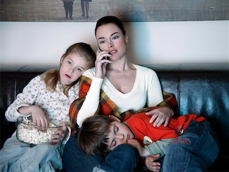 spanish mother daughter - Mother and children watching television Stock Photo - Premium Royalty-Free, Code: 644-01436476