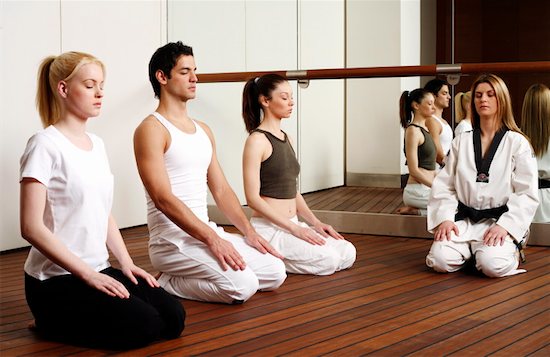 Participants in a fitness class meditating Stock Photo - Premium Royalty-Free, Image code: 644-01436509