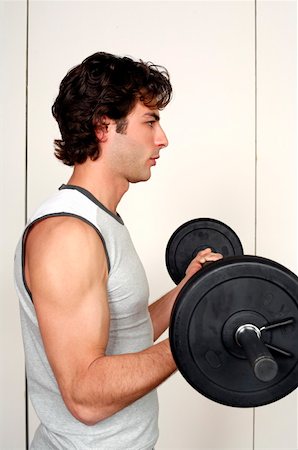simsearch:695-03375202,k - Young man lifting weights Stock Photo - Premium Royalty-Free, Code: 644-01436542