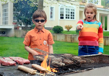 Boy and girl standing near a barbecue Stock Photo - Premium Royalty-Free, Code: 644-01436797