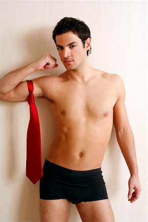 seduction tie - Bare chested young man posing with shorts and tie Stock Photo - Premium Royalty-Free, Code: 644-01436974