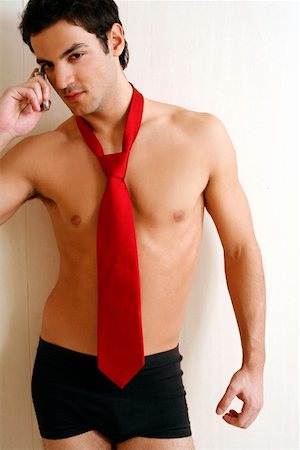 seduction tie - Bare chested young man posing with shorts and tie Stock Photo - Premium Royalty-Free, Code: 644-01436973