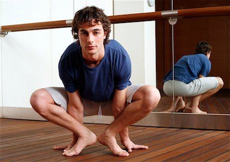 simsearch:644-01436501,k - Young man stretching Stock Photo - Premium Royalty-Free, Code: 644-01437009