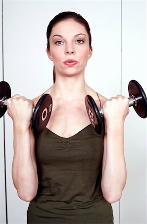 simsearch:644-01436527,k - Young woman lifting weights Fotografie stock - Premium Royalty-Free, Codice: 644-01437017