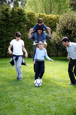 parents playing football with kids - Man and children playing soccer Stock Photo - Premium Royalty-Free, Code: 644-01437249