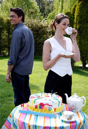 Couple with Birthday cake, teapot and cups Stock Photo - Premium Royalty-Free, Code: 644-01437242