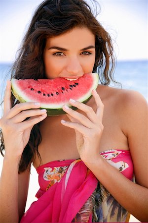 eating on the beach - Young woman on beach eating watermelon Stock Photo - Premium Royalty-Free, Code: 644-01437632