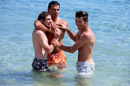 friends greece - Three young men playing in the water Stock Photo - Premium Royalty-Free, Code: 644-01437773