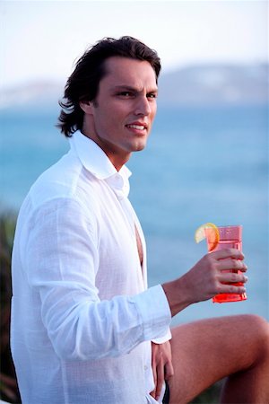 simsearch:644-01437468,k - Young man holding a cocktail Stock Photo - Premium Royalty-Free, Code: 644-01437861