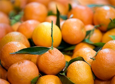 Tangerines with stem and leaves Foto de stock - Sin royalties Premium, Código: 644-01630674
