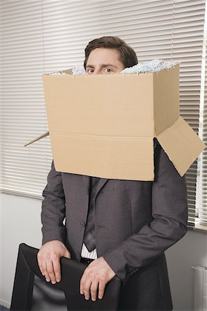 Office worker with head in a box Stock Photo - Premium Royalty-Free, Code: 644-01630912