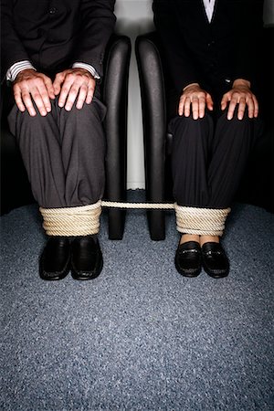 speechless - Male and female business people's legs tied Stock Photo - Premium Royalty-Free, Code: 644-01630946