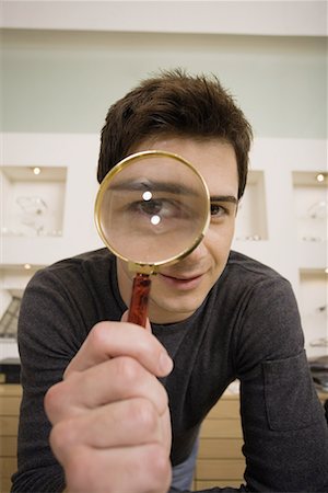 funny man with specs - Man with magnifying glass on eye Stock Photo - Premium Royalty-Free, Code: 644-01631007