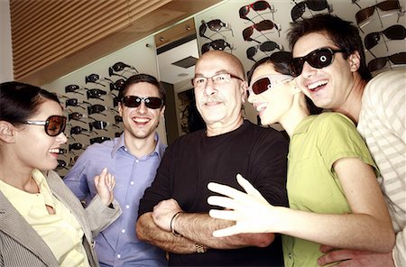 simsearch:644-01631059,k - Two couples posing with sunglasses in store with shopkeeper Foto de stock - Sin royalties Premium, Código: 644-01631028