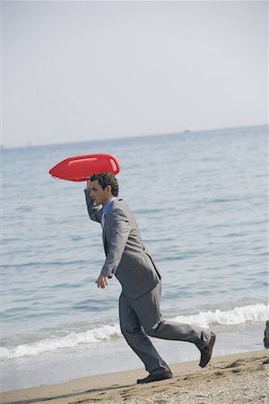 simsearch:644-01825796,k - Businessman on beach with life preserver Stock Photo - Premium Royalty-Free, Code: 644-01631115