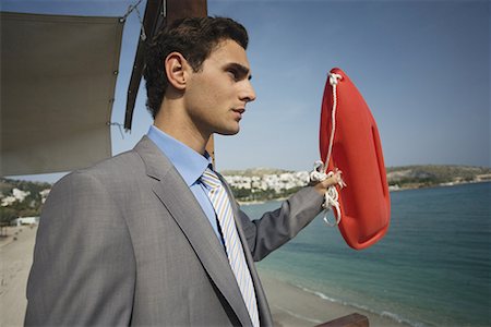 simsearch:644-01825796,k - Businessman on life guard stand with life preserver Stock Photo - Premium Royalty-Free, Code: 644-01631119