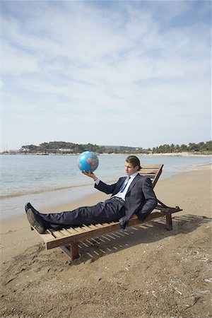 simsearch:644-01825796,k - Businessman on chaise lounge with globe Stock Photo - Premium Royalty-Free, Code: 644-01631125