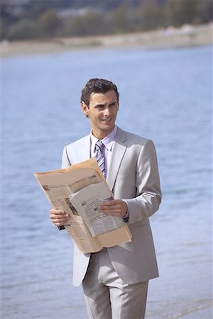 simsearch:644-01825796,k - Businessman on beach holding a newspaper Stock Photo - Premium Royalty-Free, Code: 644-01631153