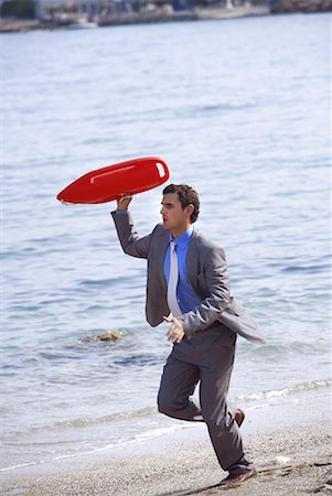 simsearch:644-01825796,k - Businessman on beach with life preserver Stock Photo - Premium Royalty-Free, Code: 644-01631177