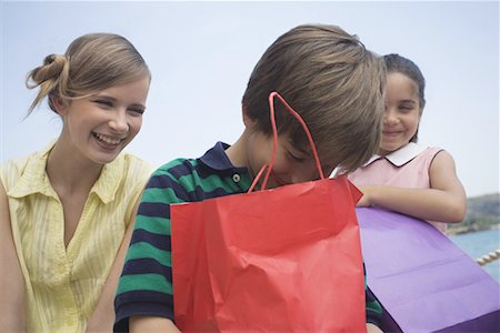 Mother and two children with shopping bags Stock Photo - Premium Royalty-Free, Code: 644-01631197