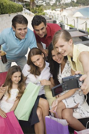 french cafe, people - Group of friends with shopping bags taking photo Stock Photo - Premium Royalty-Free, Code: 644-01631208