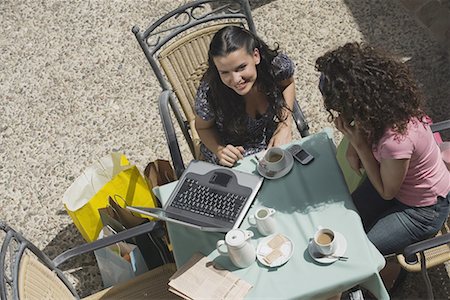 french cafe, people - Two women at a cafe with laptop and shopping bags Stock Photo - Premium Royalty-Free, Code: 644-01631243